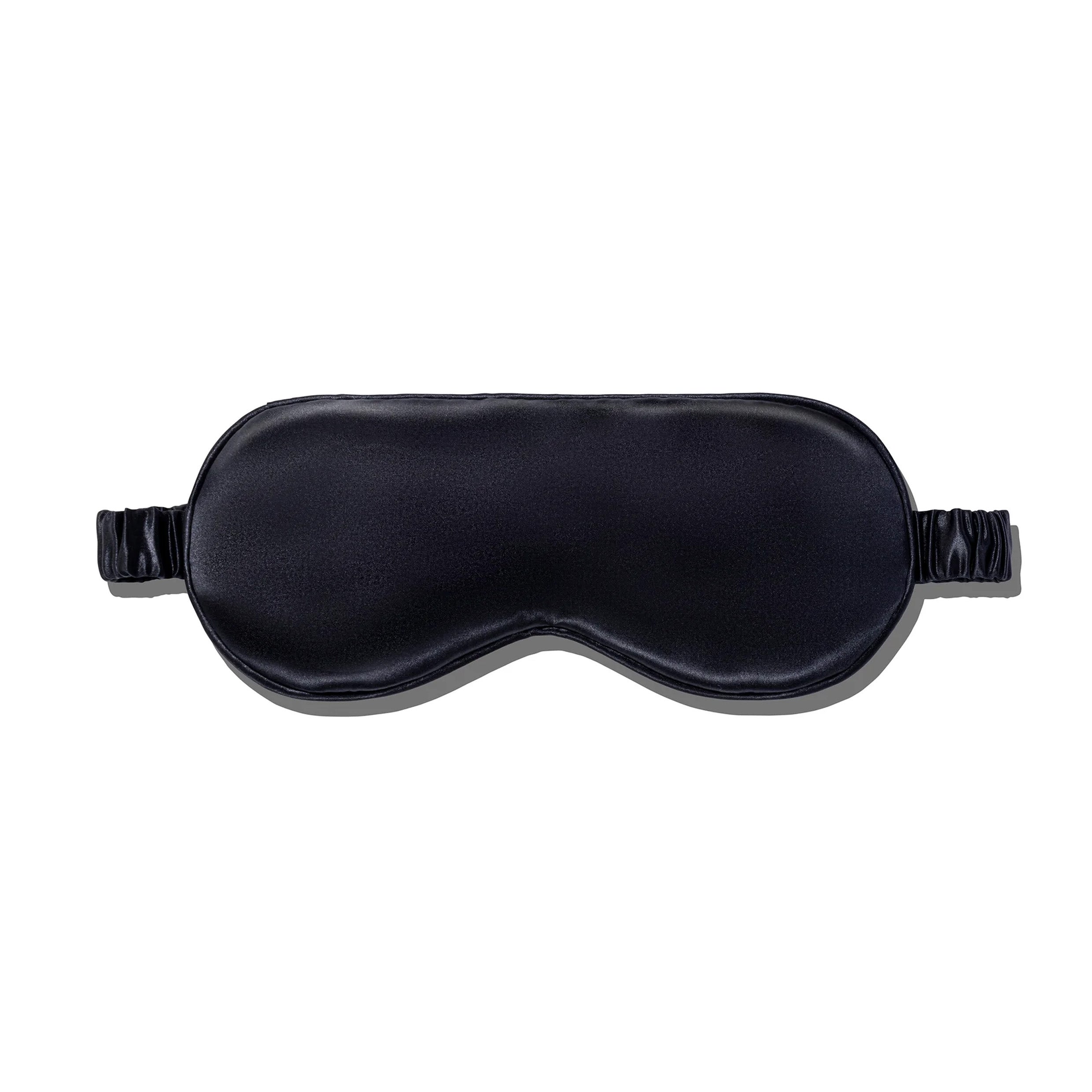A black silk sleep mask with an elastic band.