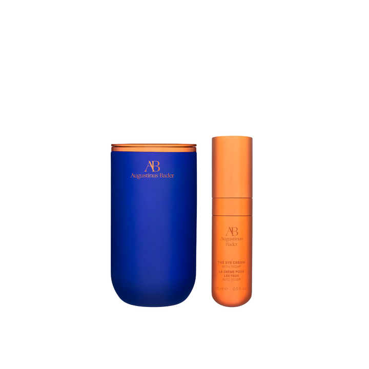 A image of Augustinus Bader The Eye Cream packaging, with a blue container on the left and an orange tube on the right, both with the brand's logo.