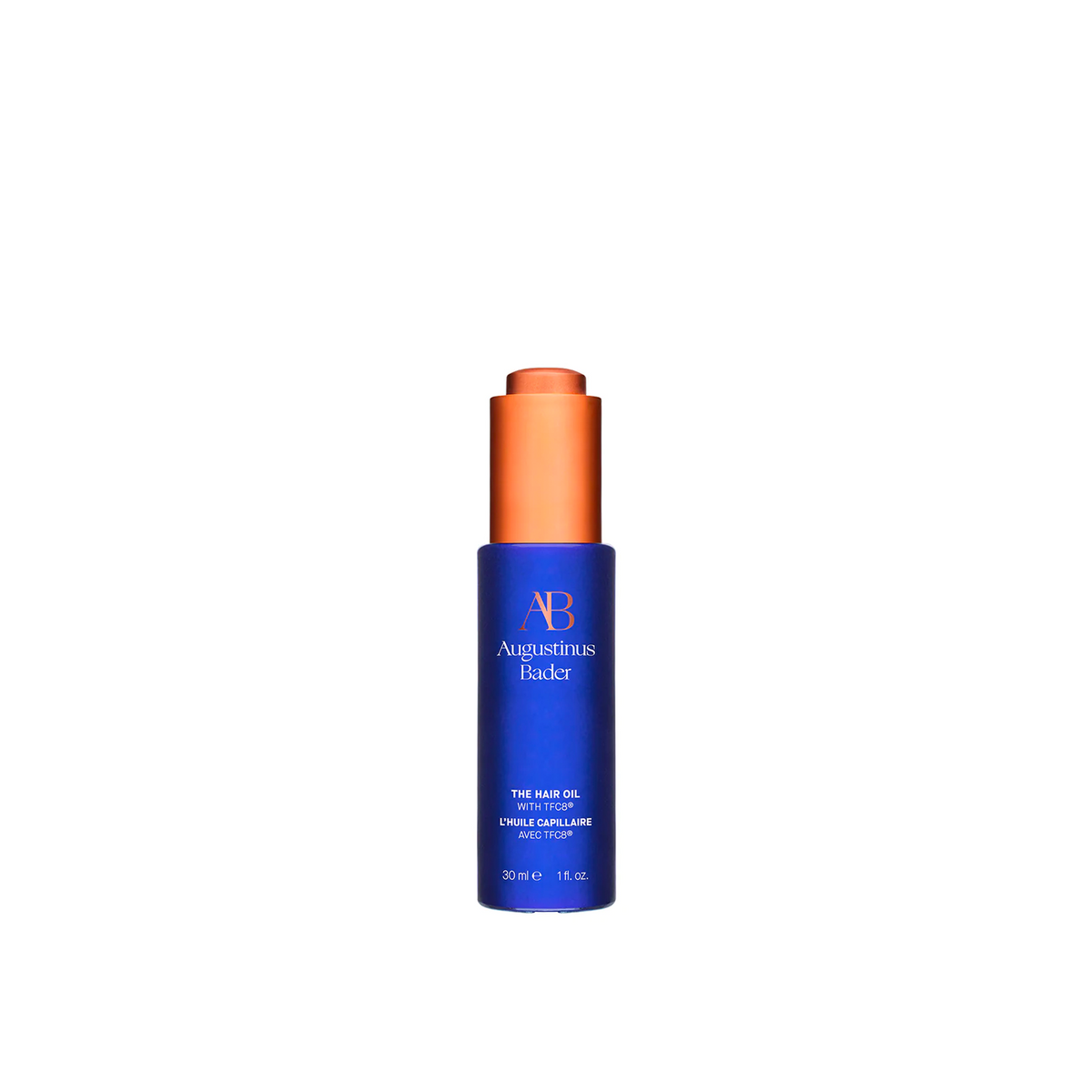 A bottle of Augustinus Bader The Hair Oil with a blue label and orange cap.