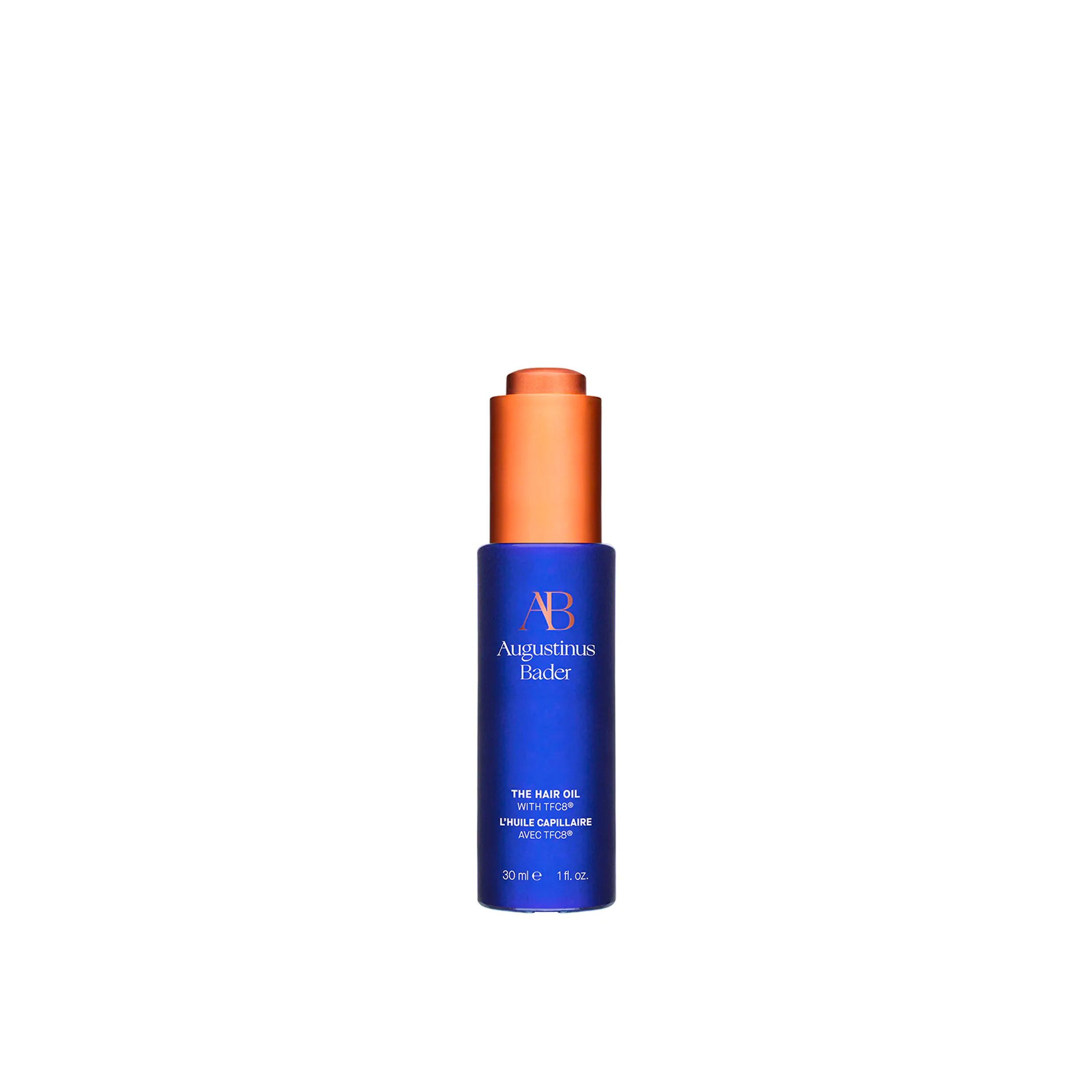 A bottle of Augustinus Bader The Hair Oil with a blue label and orange cap.