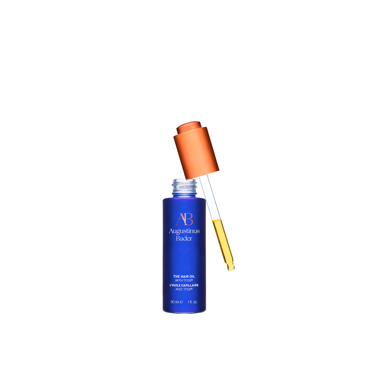 A bottle of Augustinus Bader The Hair Oil, showing the dropper included.