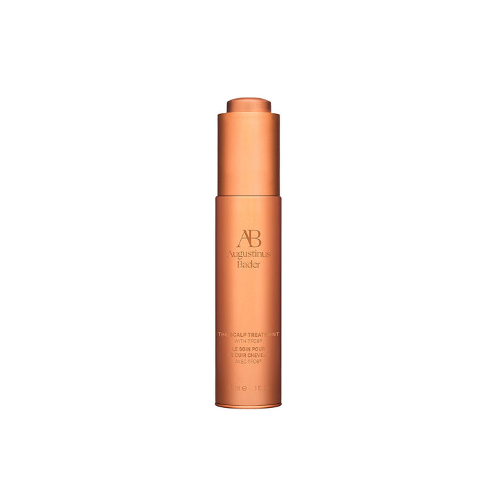 A bottle of Augustinus Bader The Scalp Treatment, designed for haircare.