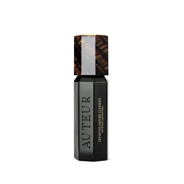 Black skincare product bottle with tortoiseshell cap on a white background