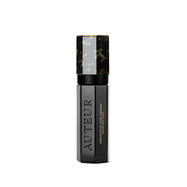 Black serum bottle with tortoiseshell cap on a white background