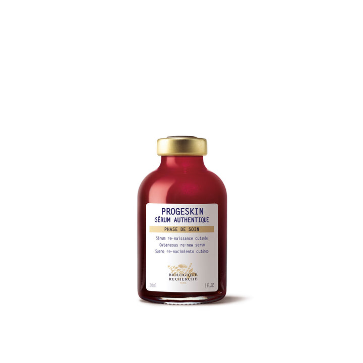 A bottle of Biologique Recherche Progeskin Serum with a red tint and a white label, displaying the product name and brand.