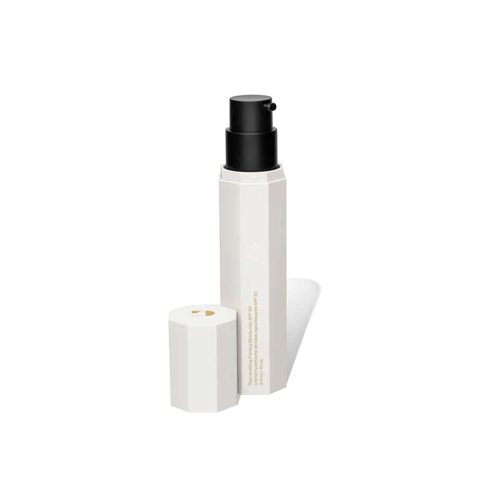 White cosmetic bottle with black cap on a white background