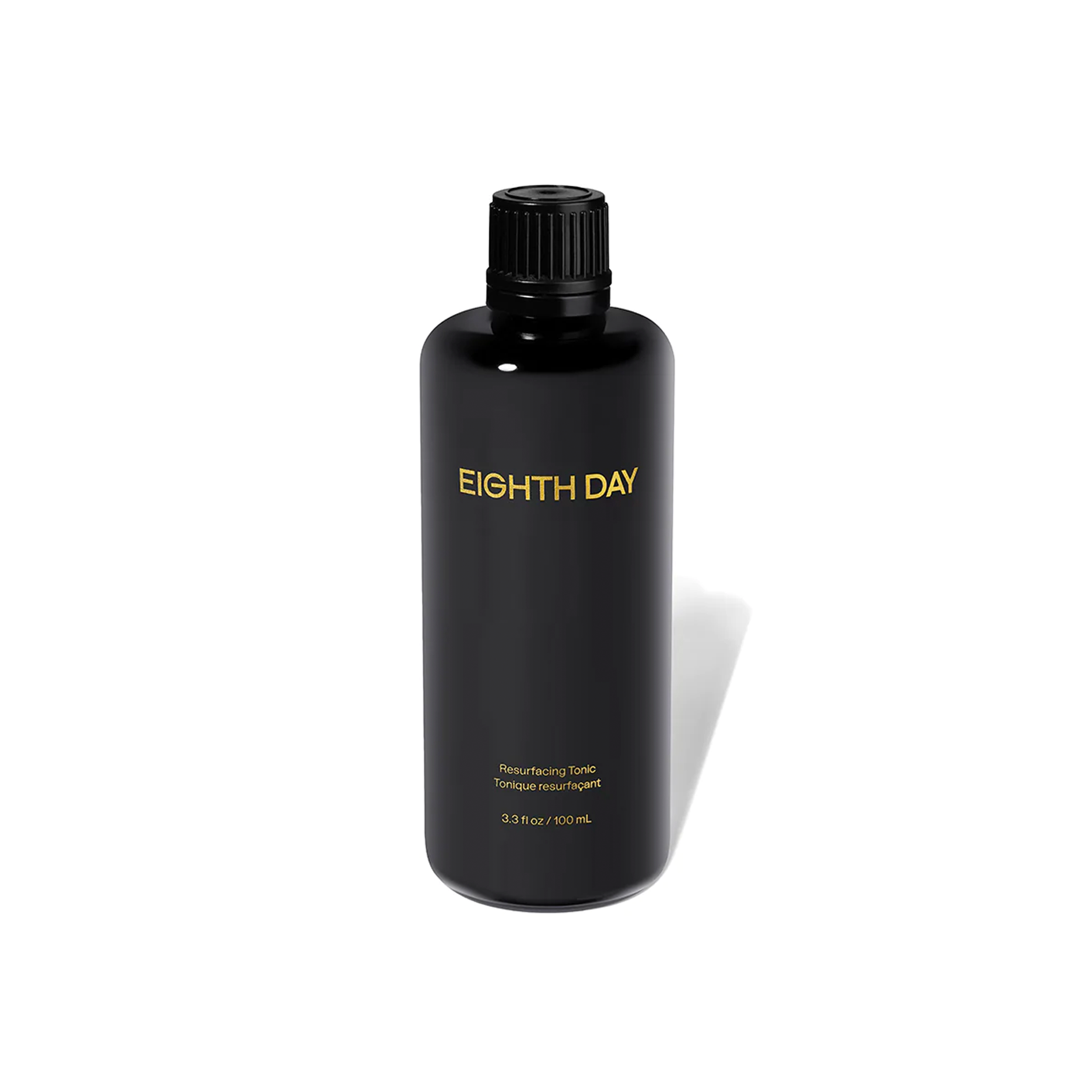 A black bottle labeled 'EIGHTH DAY' containing a resurfacing tonic for skin care.
