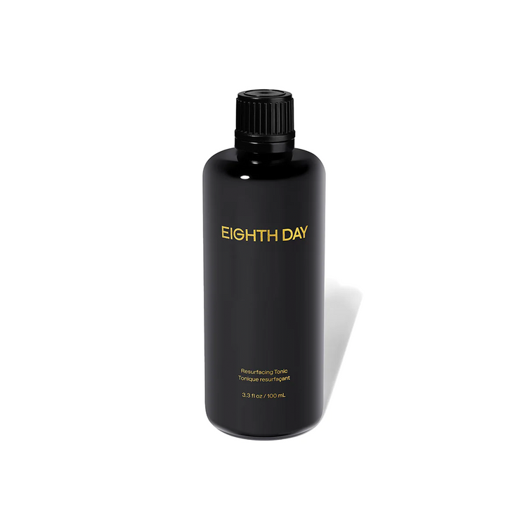 A black bottle labeled 'EIGHTH DAY' containing a resurfacing tonic for skin care.