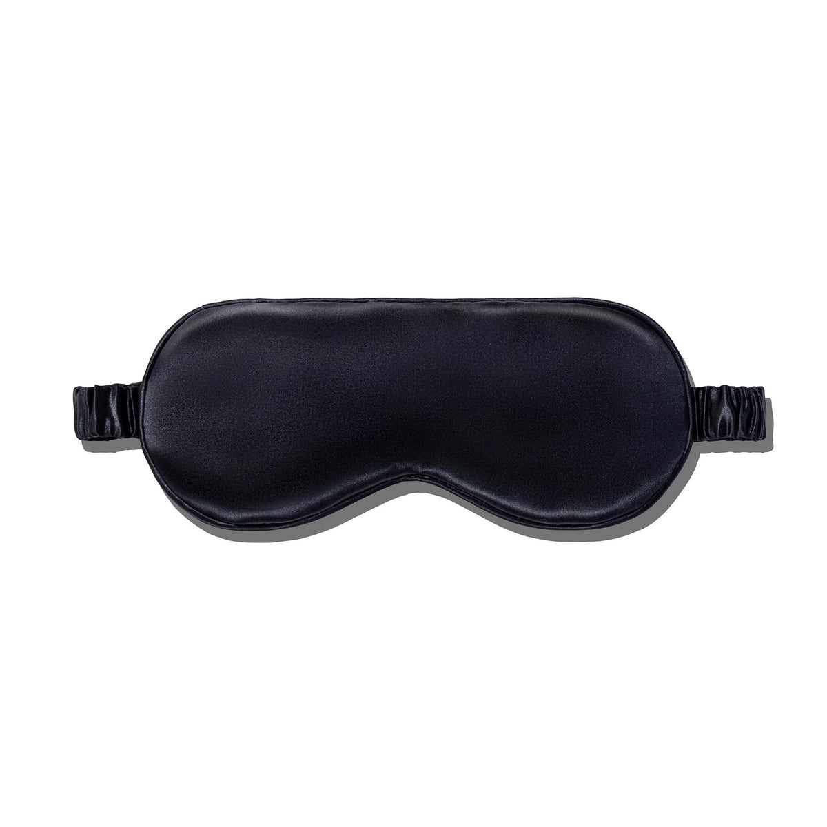 A black silk sleep mask with an elastic band.