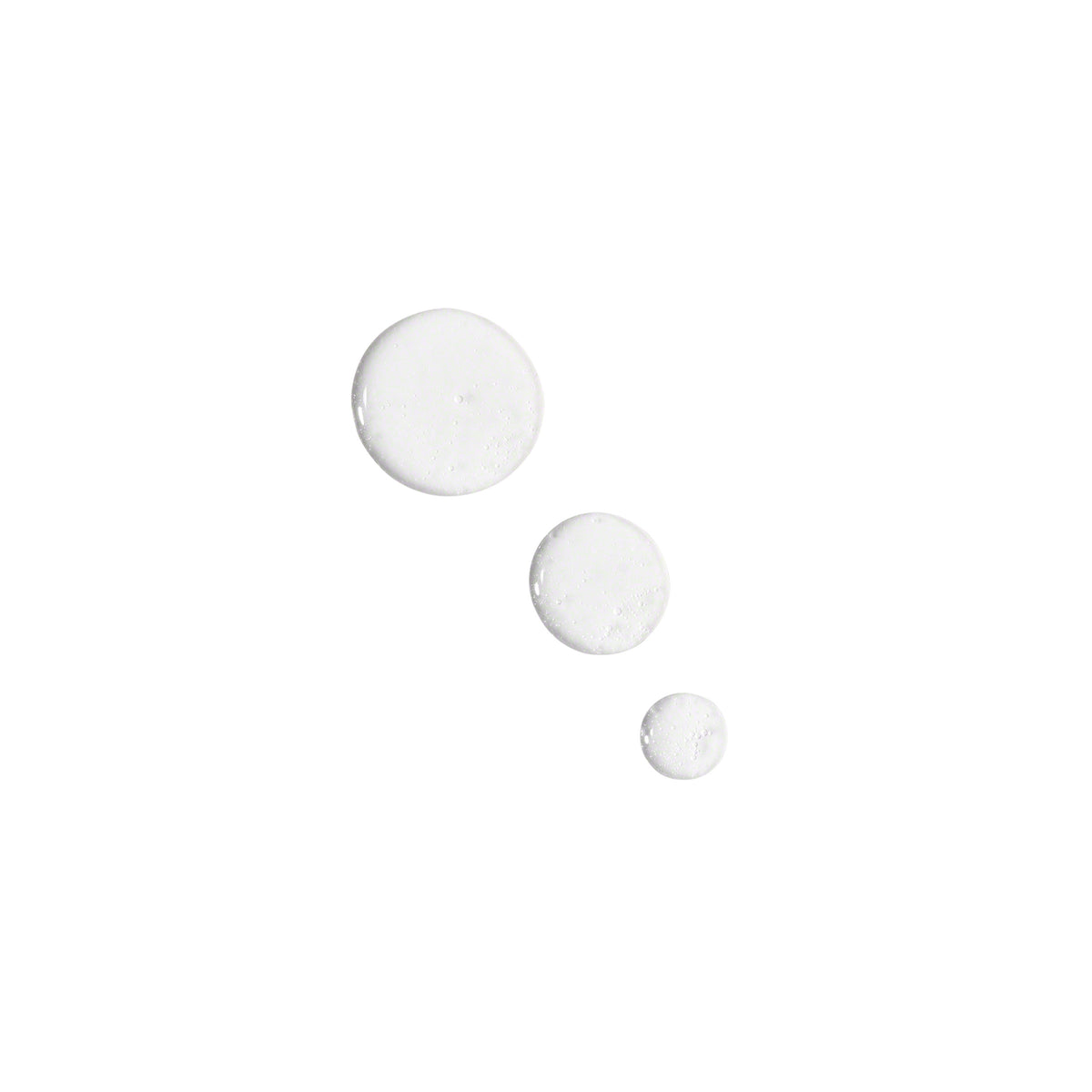 Droplets of Valmont LumiSence, clear liquid shown on a white background.