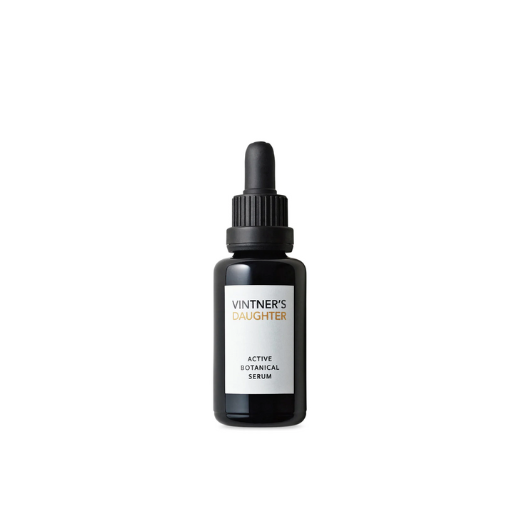 A black dropper bottle of Vintner's Daughter Active Botanical Serum with white and silver text labeling.
