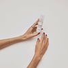 A GIF showing a white pump bottle containing face serum