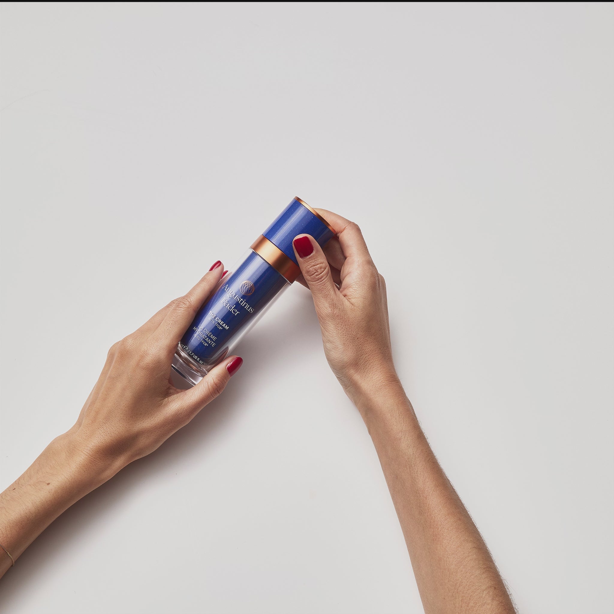A GIF featuring a bottle of Augustinus Bader The Cream